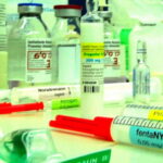 Zusammenstellung von Medikamenten für die Narkose: Im Fokus eine Ampulle „Propofol“ (200 mg), flankiert von aufgezogenen Spritzen mit „fentaNYL“ und „Atropin“ sowie Infusionsflaschen im Hintergrund.